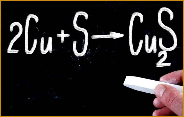 cropped image of person holding chalk against formula on blackboard 57d df78c d 456714