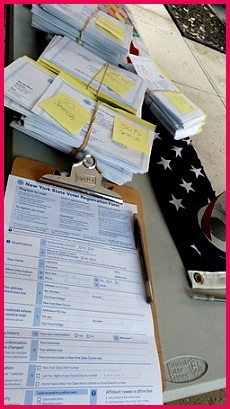 an English language New York State voter registration form on a clipboard with a pen